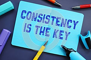 Financial concept about Consistency Is The Key with inscription on the piece of paper