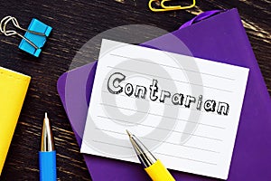 Financial concept about Contrarian with phrase on the piece of paper photo