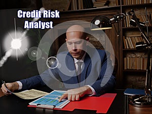 Financial concept about Credit Risk Analyst Male office workers with yellow shirt holding and writing documents on office desk