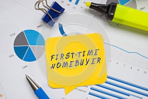 Financial concept about FIRST-TIME HOMEBUYER with inscription on the sheet