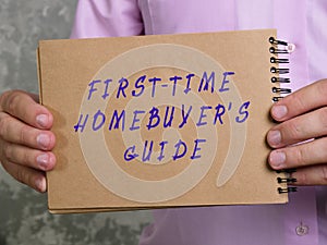 Financial concept about FIRST-TIME HOMEBUYER`S GUIDE with phrase on the piece of paper