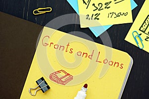 Financial concept about Grants And Loans with phrase on the page