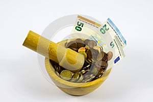 Financial Concept of Inflation - Euro Bills crushed to coins in a mortar grinded by a pestle