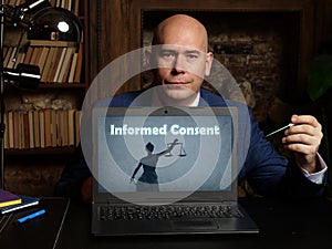 Financial concept about Informed Consent with sign on laptop in hand