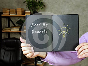 Financial concept about Lead By Example with phrase on the page