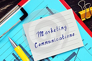 Financial concept about Marketing Communications with phrase on the piece of paper