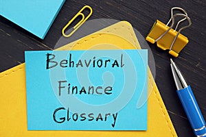 Financial concept meaning Behavioral Finance Glossary with inscription on the piece of paper