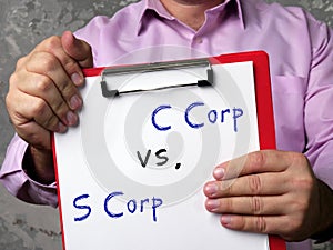 Financial concept meaning C Corp vs. S Corp with inscription on the piece of paper