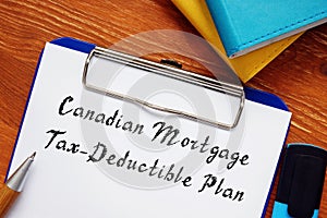 Financial concept meaning Canadian Mortgage Tax-Deductible Plan with inscription on the piece of paper