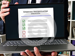 Financial concept meaning Corporate Reorganization Checklist with phrase on the page photo