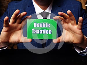 Financial concept meaning Double Taxation with inscription on green business card