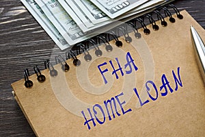 Financial concept meaning FHA HOME LOAN with inscription on the piece of paper