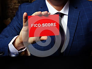 Financial concept meaning FICO SCORE with sign on the page. Concept about a credit score created by the Fair Isaac Corporation
