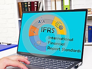 Financial concept meaning IFRS International Financial Report Standards with phrase on the page