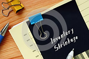 Financial concept meaning Inventory Shrinkage with sign on the sheet photo