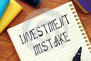 Financial concept meaning INVESTMENT MISTAKE question marks with inscription on the page