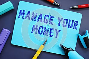 Financial concept meaning Manage Your Money with phrase on the piece of paper