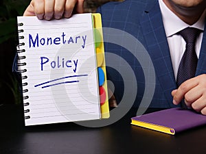Financial concept meaning Monetary Policy with sign on white notepad