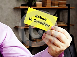 Financial concept meaning Notice to Creditors with sign on the yelow business card