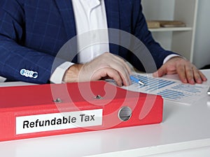 Financial concept meaning Refundable Tax with inscription on the document case