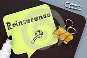 Financial concept meaning Reinsurance with inscription on the piece of paper
