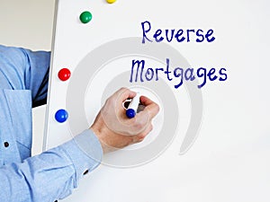 Financial concept meaning Reverse Mortgages with phrase on the piece of paper