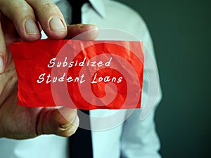 Financial concept meaning Subsidized Student Loans with inscription on the sheet