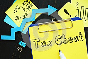 Financial concept meaning Tax Cheat with sign on the piece of paper