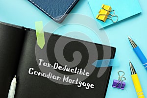 Financial concept meaning Tax-Deductible Canadian Mortgage with phrase on the piece of paper