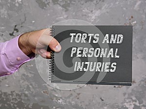 Financial concept meaning TORTS AND PERSONAL INJURIES with inscription on the sheet