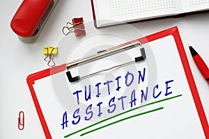 Financial concept meaning TUITION ASSISTANCE with sign on the page