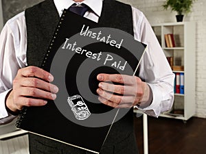 Financial concept meaning Unstated Interest Paid with phrase on the page