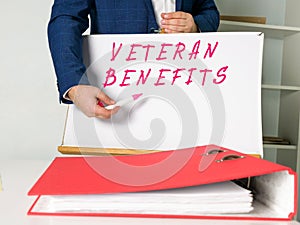Financial concept meaning VETERAN BENEFITS with inscription on the piece of paper