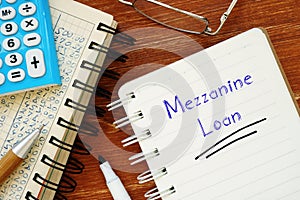 Financial concept about Mezzanine Loan with inscription on the piece of paper