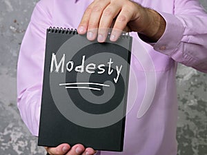 Financial concept about Modesty with sign on the piece of paper