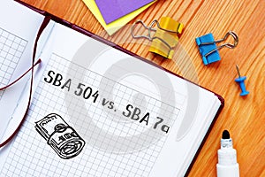 Financial concept about SBA 504 vs SBA 7a with sign on the piece of paper photo
