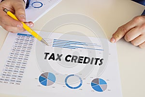 Financial concept about TAX CREDITS with inscription on the printout with diagrams and tables