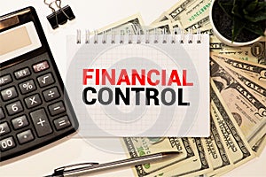 Financial CONTROL words on a green sheet of paper with a pen on the background of the chart. Business concept