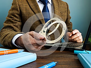 Financial crime concept. A man in a suit gives handcuffs.