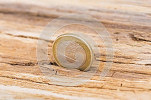 Financial crisis concept. Euro coin on old wooden background