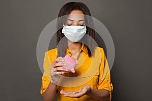 Financial crisis and global pandemic covid-19. Unhappy black woman in medical mack without money photo