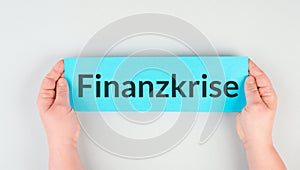 Financial crisis is standing in german language on the paper, economic recession, inflation and crash stock market and political