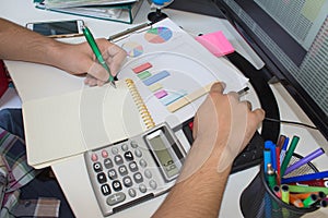 Financial data analyzing. Counting on calculator. Hand on calculator