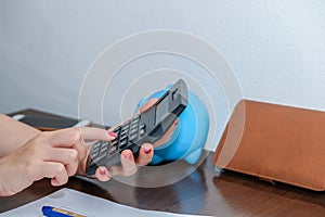 Financial data analyzing hand writing and counting on calculator at home on wooden desk