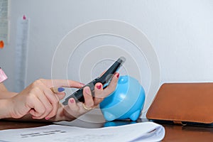 Financial data analyzing hand writing and counting on calculator at home on wooden desk