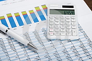 Financial Data Sheet With Calculator And Pen