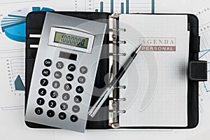 Financial diary and pen lying in the diagram