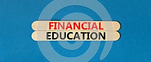 Financial education symbol. Concept words Financial education on beautiful wooden stick. Beautiful blue paper background. Business