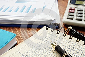 Financial figures in an accounting book and business analytical graphs