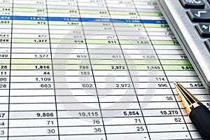 Financial forms with pen and calculator.